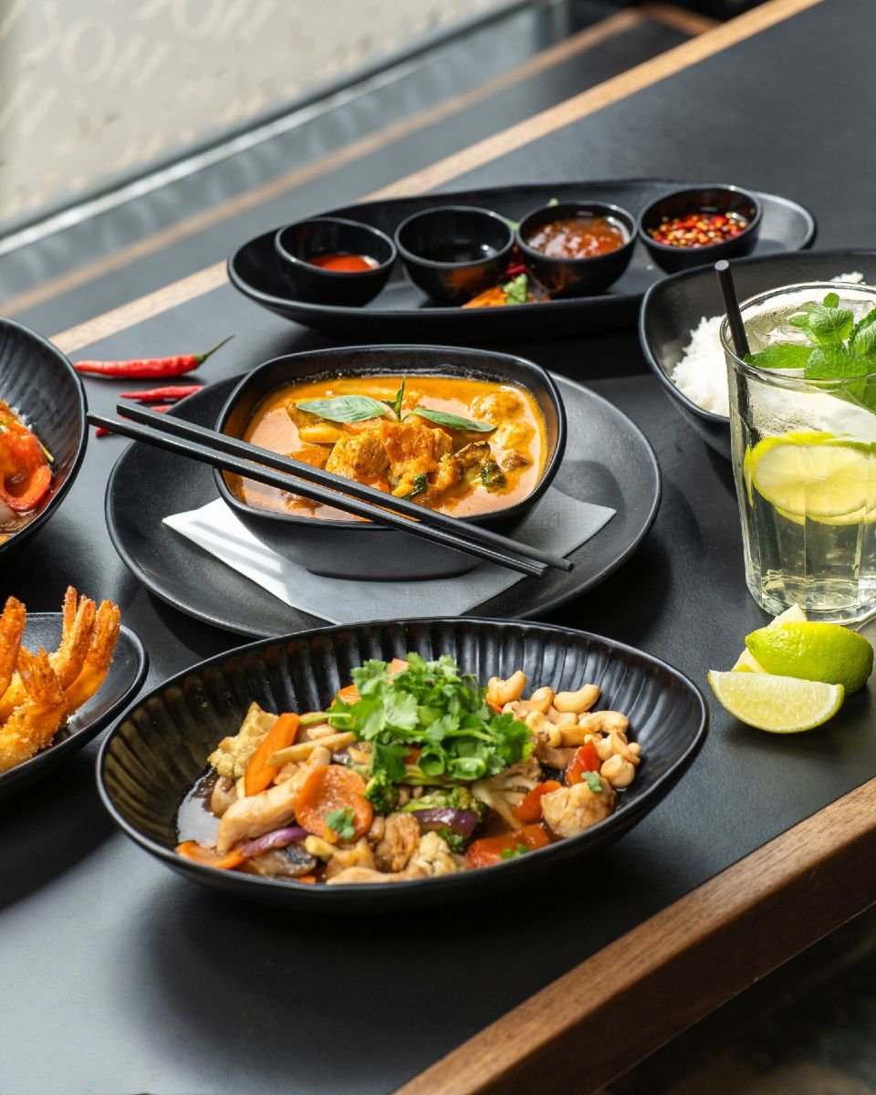 Diners at a warm, wood-toned restaurant